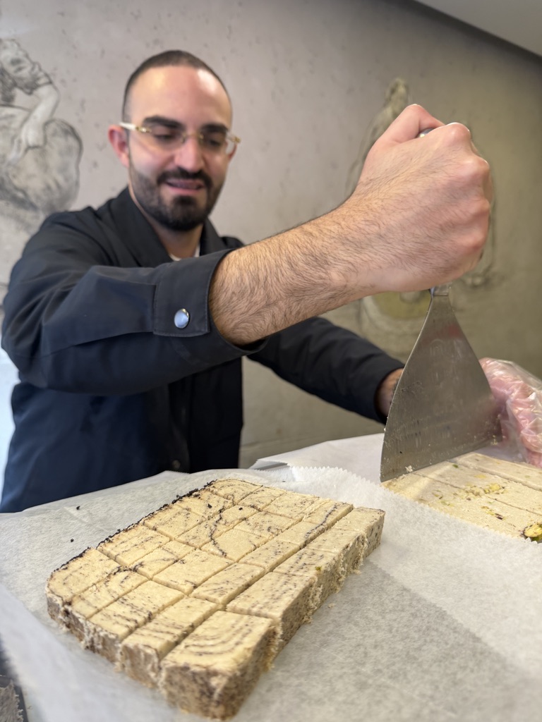 Halva being sliced fresh at a specialty halva shop in Levinsky Market Tel Aviv.
