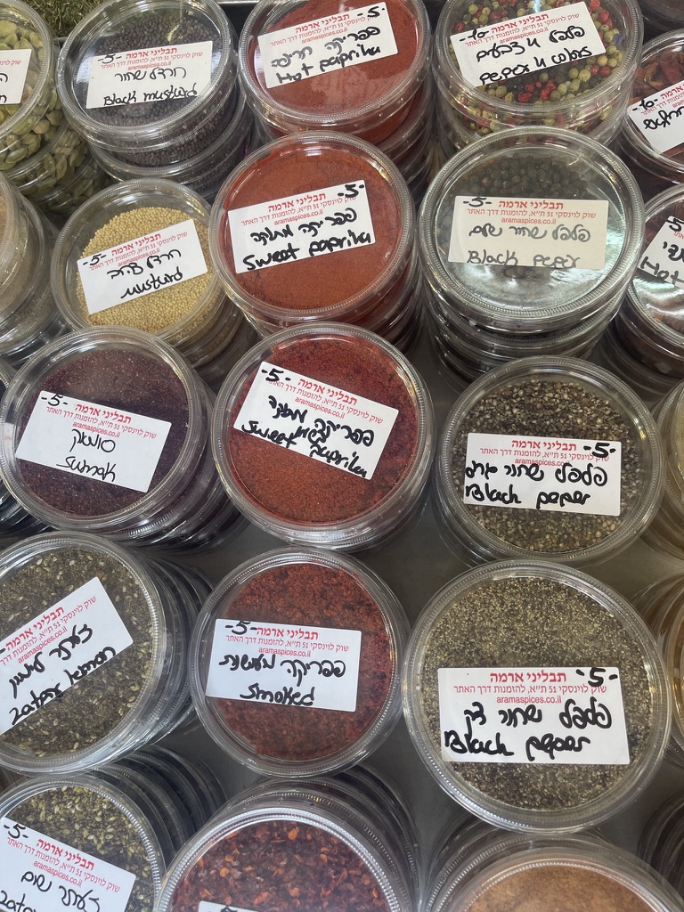 Spices on sale at Arma spice store in Levinsky market in Tel Aviv showing za'atar, smoked paprika, black pepper, and sumac.
