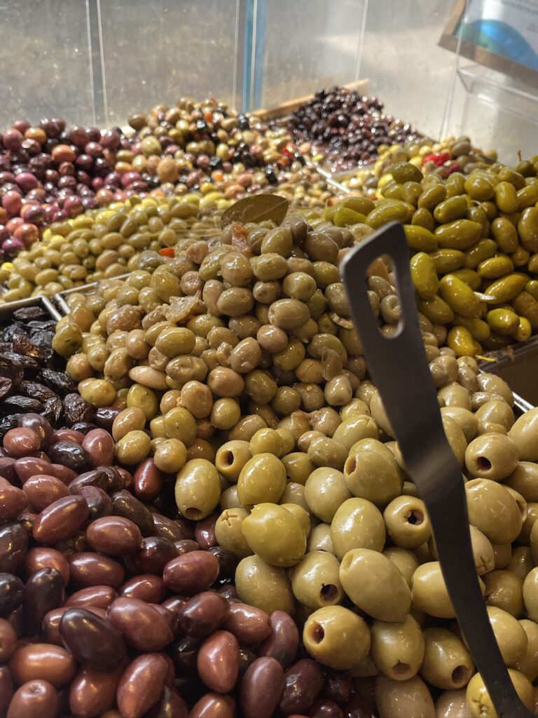 Colorful display of marinated and cured olives at Yom Tov Delicatessen in Levinsky Market Tel Aviv.