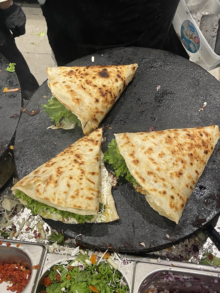 Fresh mufleta being cooked on a griddle at Nuna in Mahane Yehuda Market, Jerusalem.