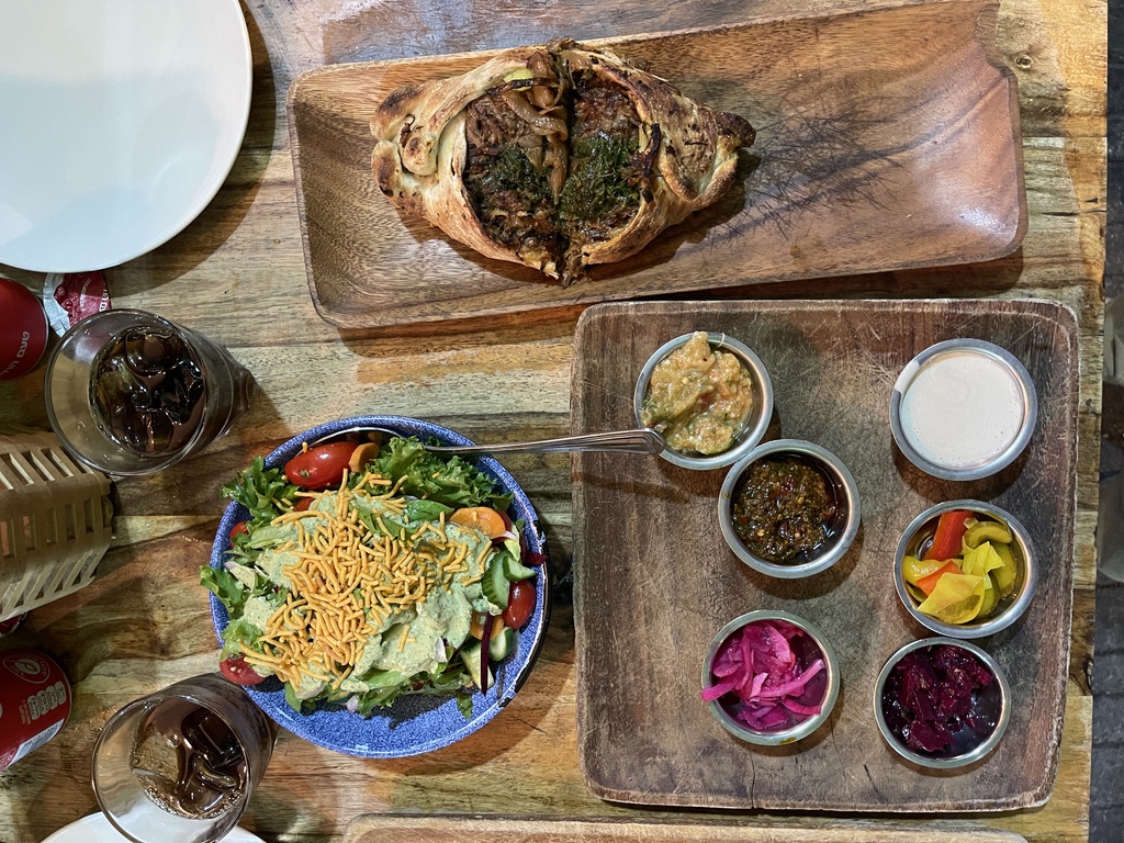 Shamburak pastries baking in a taboon oven at Ishtabach in Mahane Yehuda Market, Jerusalem