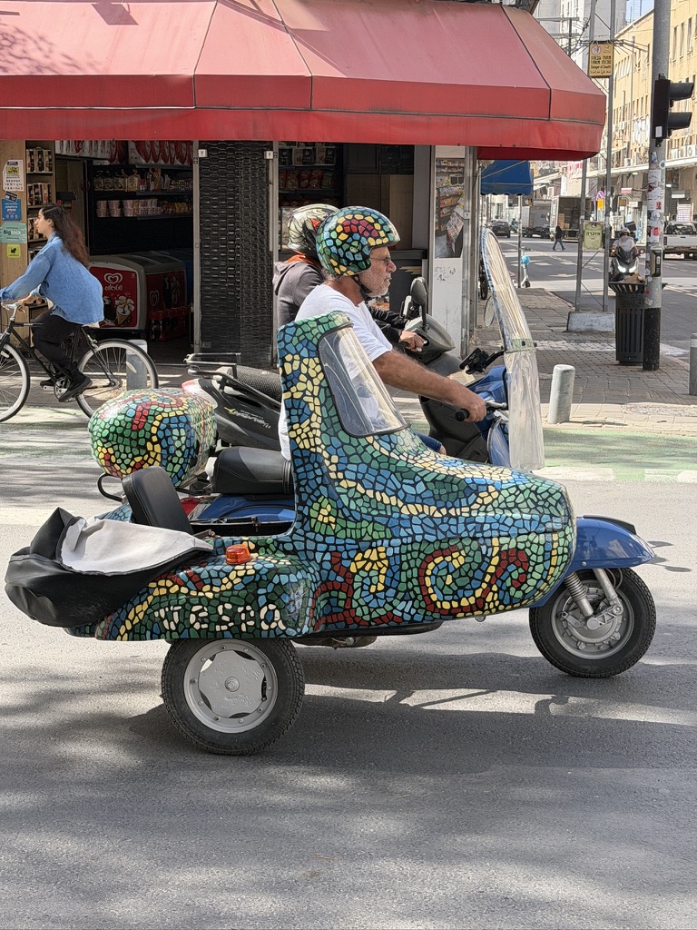 Scooter decorated with embossed tiles on a Florentin street reflecting the neighborhood's alternative and artsy character near Levinsky Market Tel Aviv.
